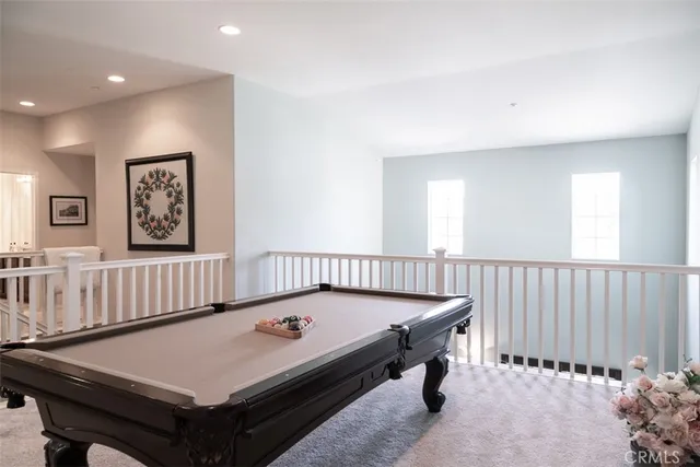 a room with furniture pool table and windows