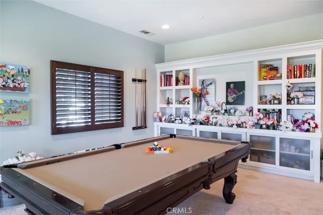 a room with furniture pool table and window