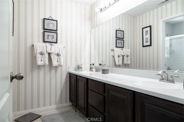 a bathroom with a double vanity sink and mirror