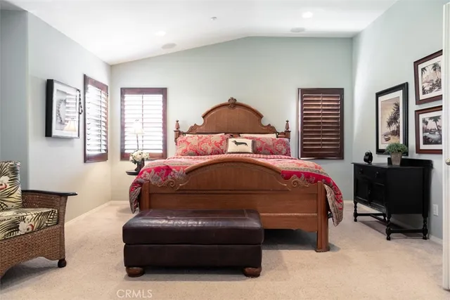 a bedroom with a bed chair and window
