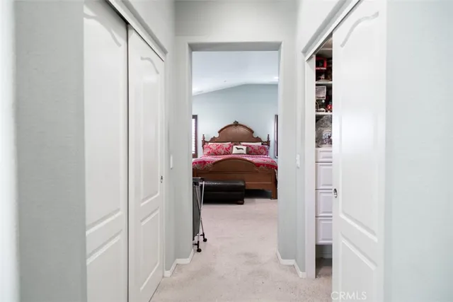 a bedroom with a bed and a white cabinet