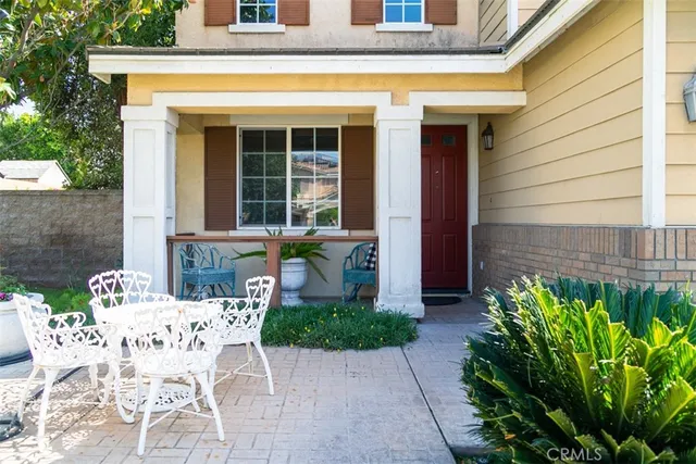 a view of a patio with table and chairs and potted plants