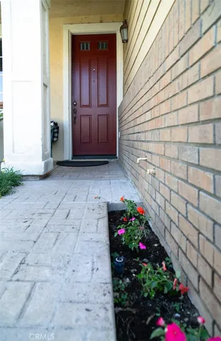 a view of a house with flower pots