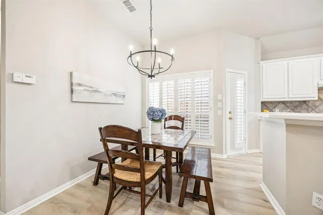 a dining room with furniture and window