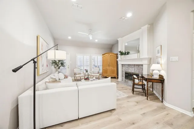 a view of living room with furniture and a fireplace