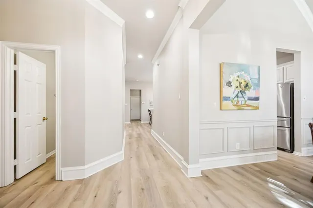 a view of a hallway view with wooden floor and staircase