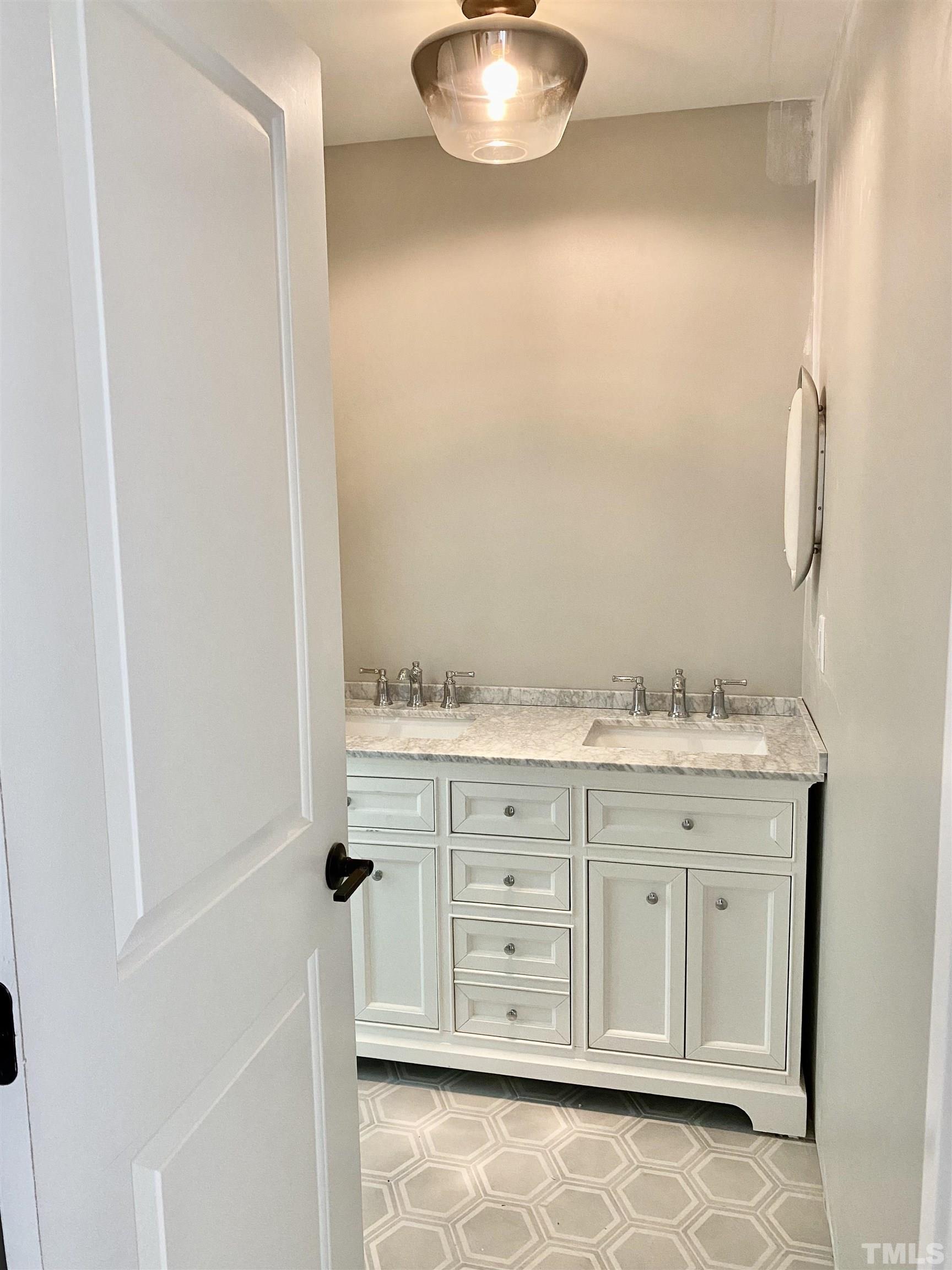 3806 Regent Road Durham, NC 27707 - Photo 13 of 21 a bathroom with a granite countertop sink and a mirror