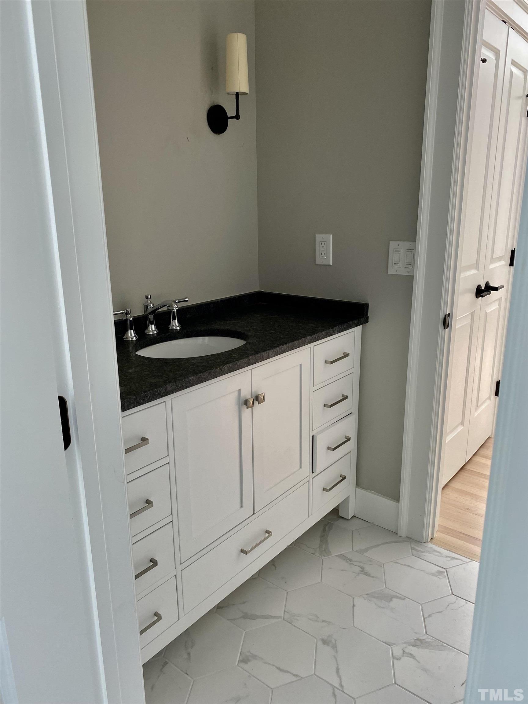 3806 Regent Road Durham, NC 27707 - Photo 14 of 21 a kitchen with white cabinets and sink