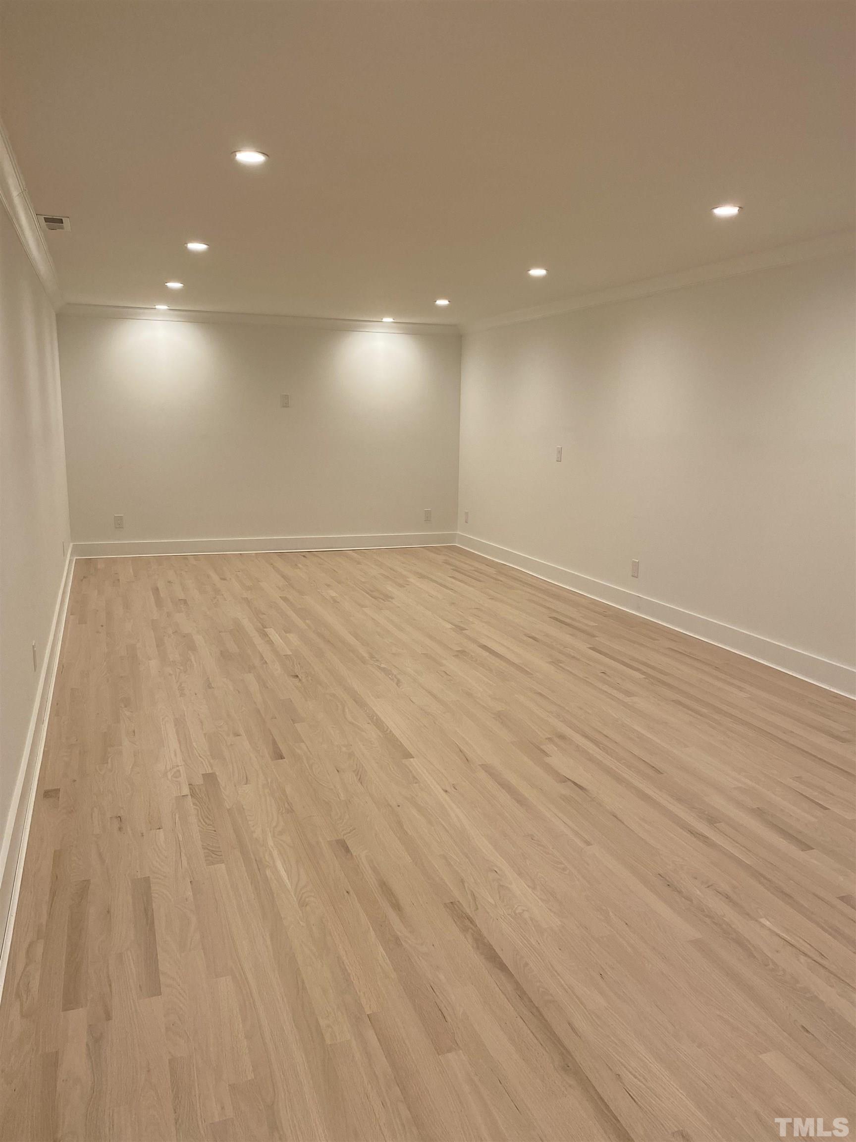 3806 Regent Road Durham, NC 27707 - Photo 19 of 21 an empty room with wooden floor and windows