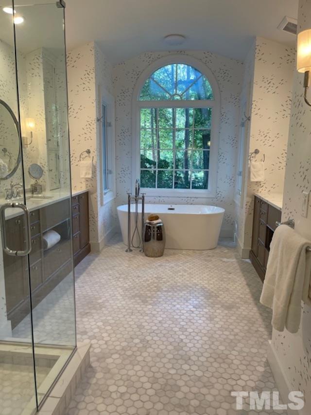 3806 Regent Road Durham, NC 27707 - Photo 20 of 21 a spacious bathroom with a granite countertop tub sink and mirror