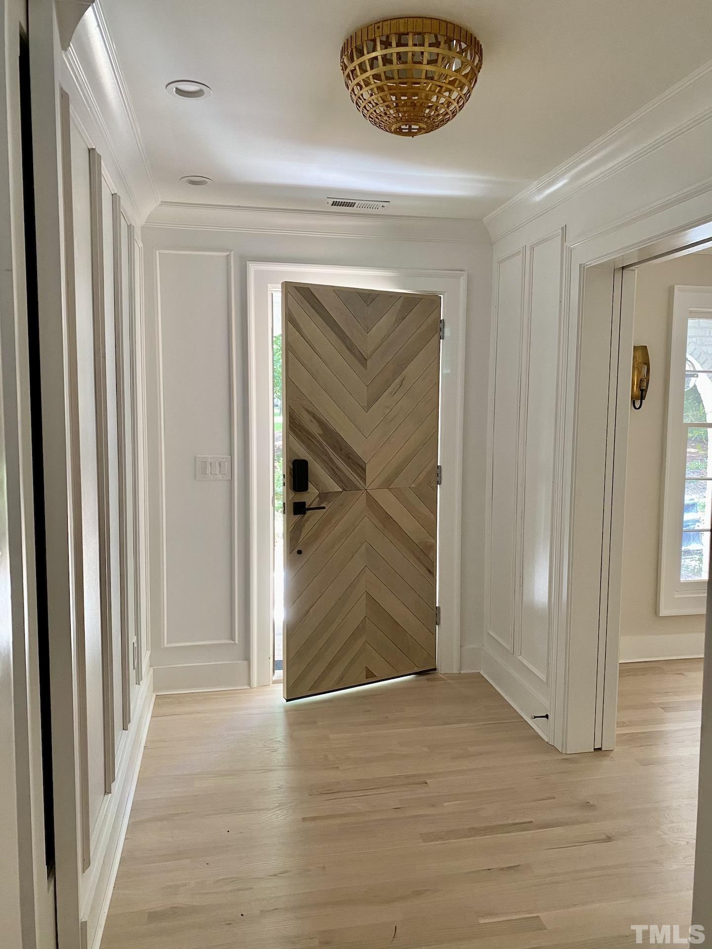 3806 Regent Road Durham, NC 27707 - Photo 5 of 21 a view of a hallway with wooden floor and a cabinet