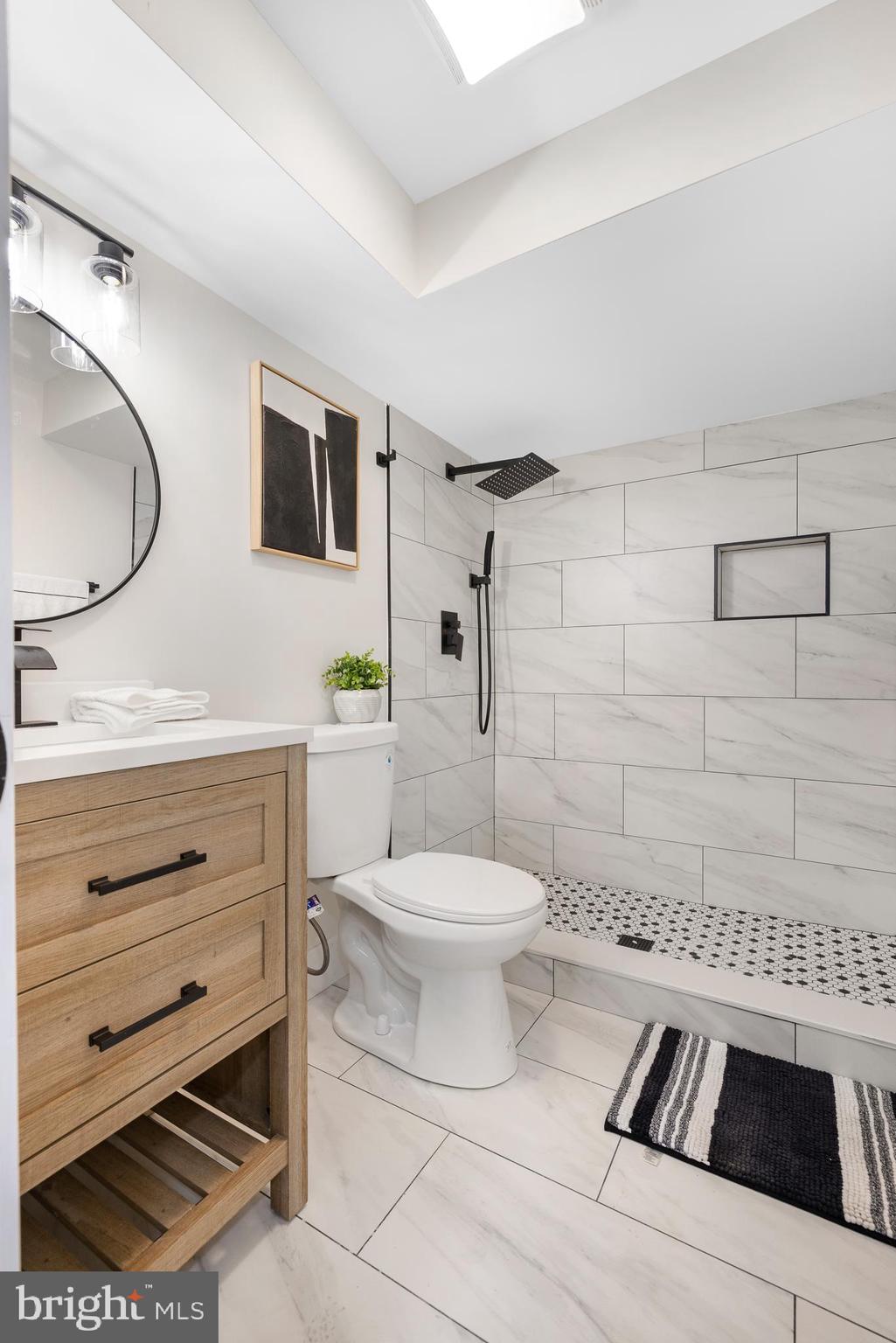 63 Childs Road Elkton, MD 21921 - Photo 25 of 44 a bathroom with a toilet a sink a mirror and shower