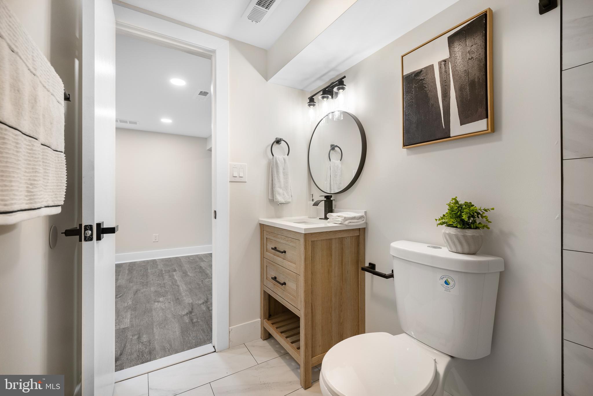 63 Childs Road Elkton, MD 21921 - Photo 26 of 44 a bathroom with a toilet a sink and mirror