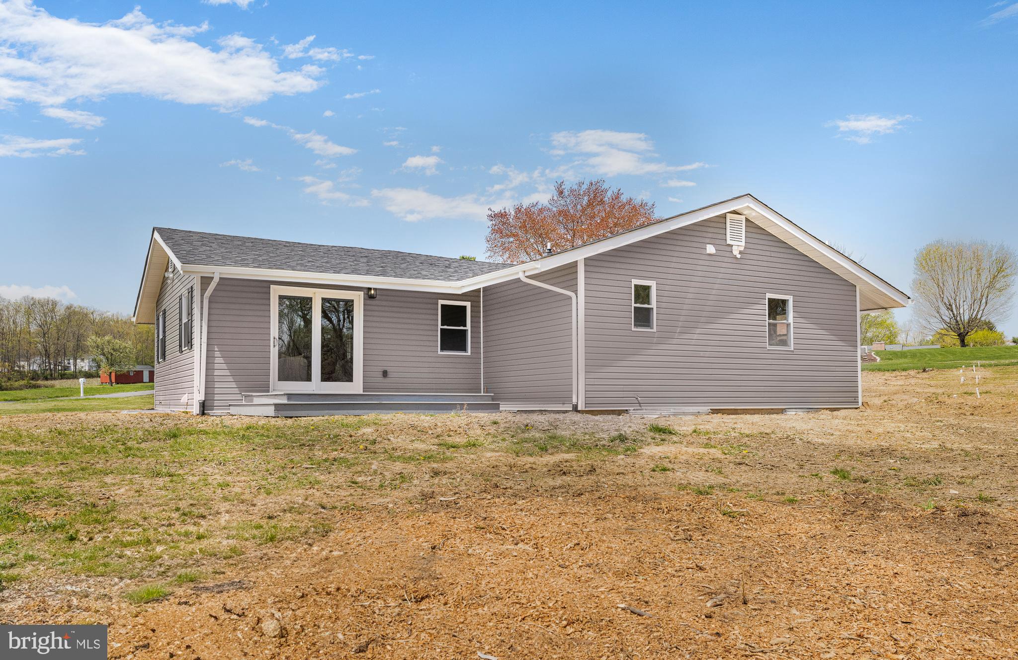 63 Childs Road Elkton, MD 21921 - Photo 40 of 44 a front view of house with yard and trees in the background