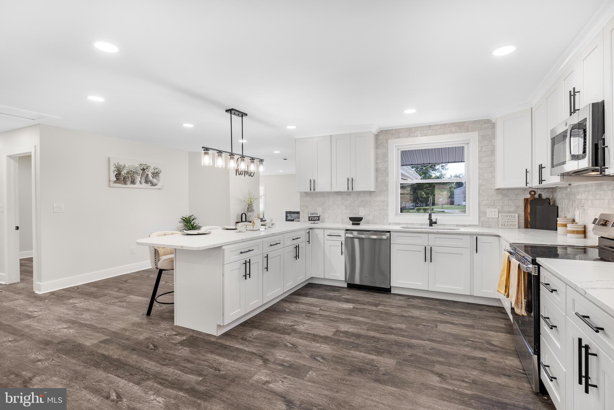63 Childs Road Elkton, MD 21921 - Photo 8 of 44 a kitchen with a white cabinets stove and sink