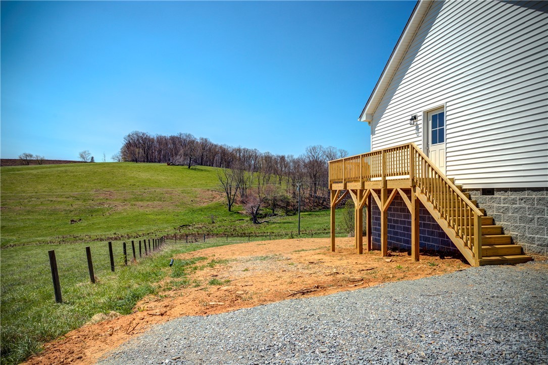 1052 Halsey Knob Road Sparta, NC 28675 - Photo 11 of 28 a view of a backyard with a garden and deck