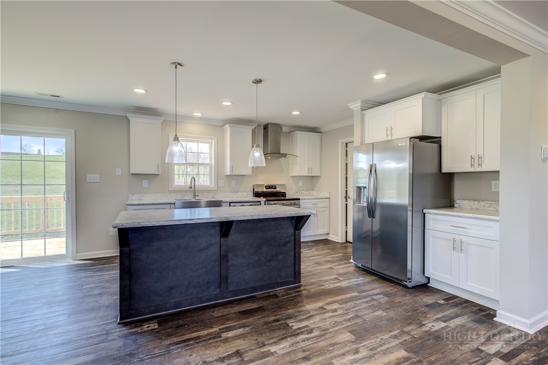 1052 Halsey Knob Road Sparta, NC 28675 - Photo 15 of 28 a kitchen with stainless steel appliances granite countertop a refrigerator a sink dishwasher a oven and a large island with wooden floor