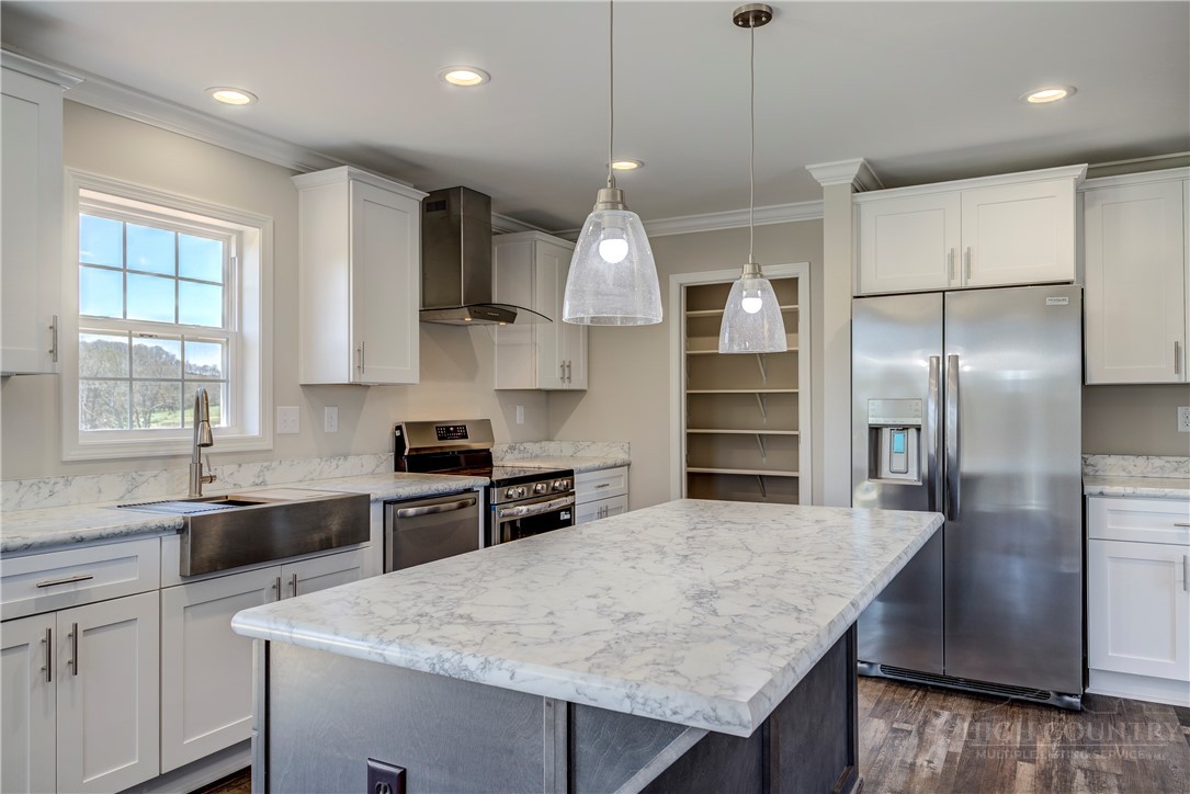1052 Halsey Knob Road Sparta, NC 28675 - Photo 17 of 28 a kitchen with stainless steel appliances granite countertop a sink a stove and a refrigerator