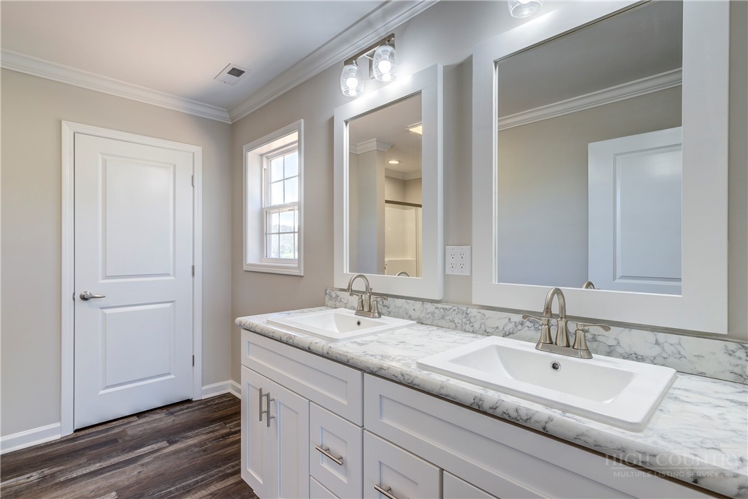 1052 Halsey Knob Road Sparta, NC 28675 - Photo 20 of 28 a bathroom with 2 sink and a mirror
