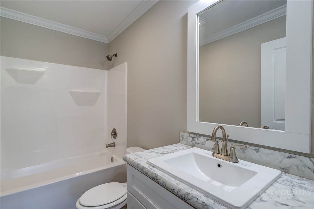 1052 Halsey Knob Road Sparta, NC 28675 - Photo 23 of 28 a bathroom with a sink toilet bathtub and shower