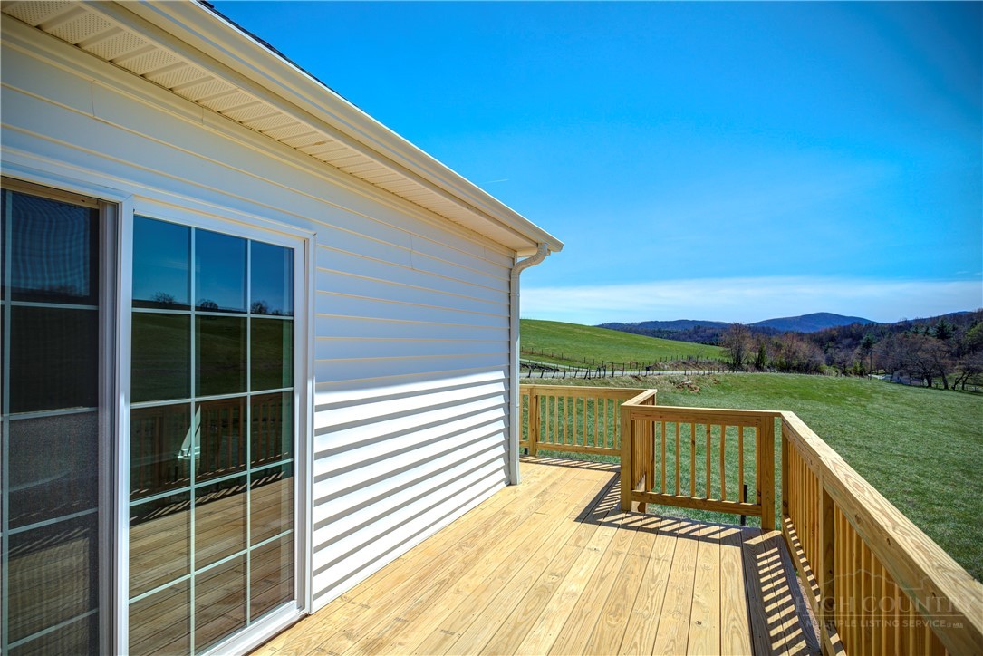 1052 Halsey Knob Road Sparta, NC 28675 - Photo 24 of 28 a view of a balcony with a floor to ceiling window and wooden fence