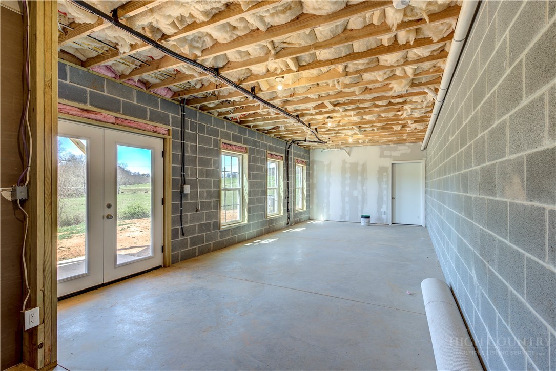 1052 Halsey Knob Road Sparta, NC 28675 - Photo 28 of 28 a view of an empty room with a sliding door