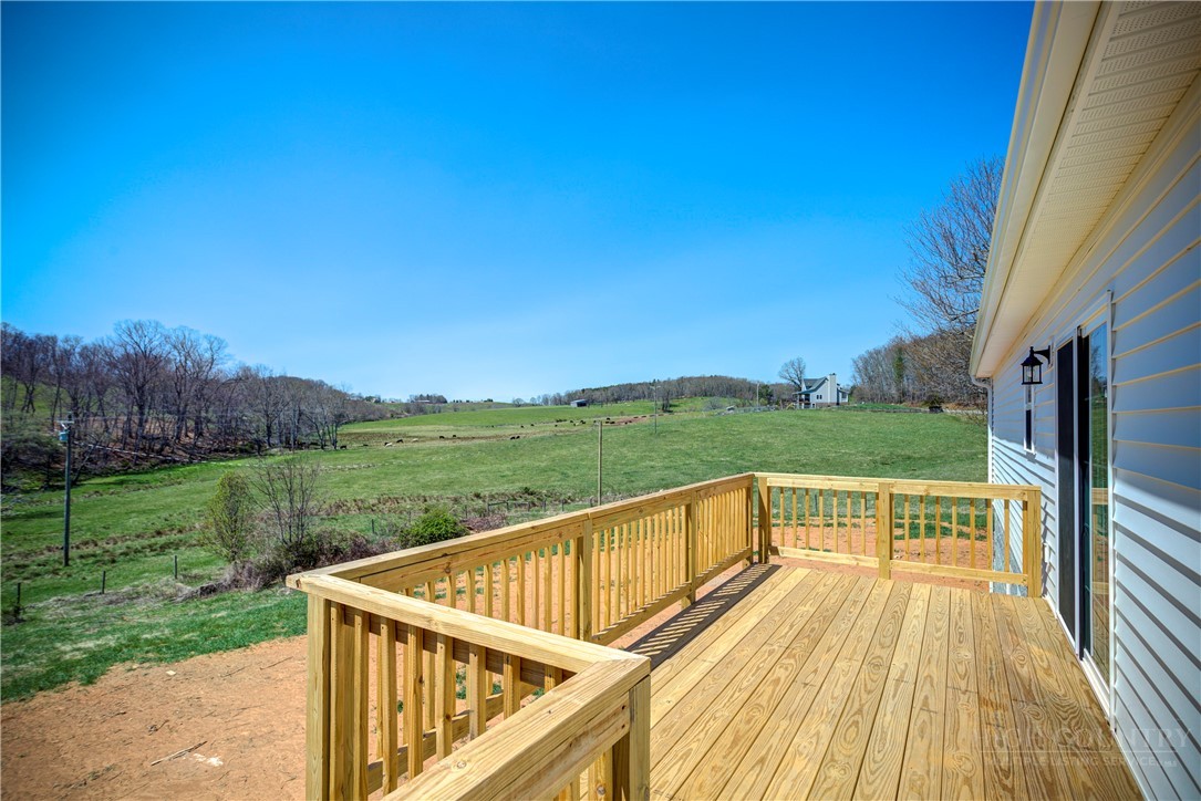 1052 Halsey Knob Road Sparta, NC 28675 - Photo 10 of 28 a view of a wooden deck and garden with wooden fence
