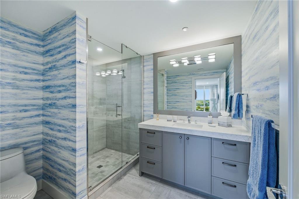 13925 Old Coast Road, Unit 905 Naples, FL 34110 - Photo 11 of 48 a bathroom with a sink a toilet and shower