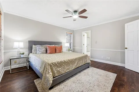 a bedroom with a large bed and a chandelier