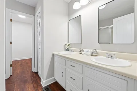 a bathroom with a double vanity sink and mirror