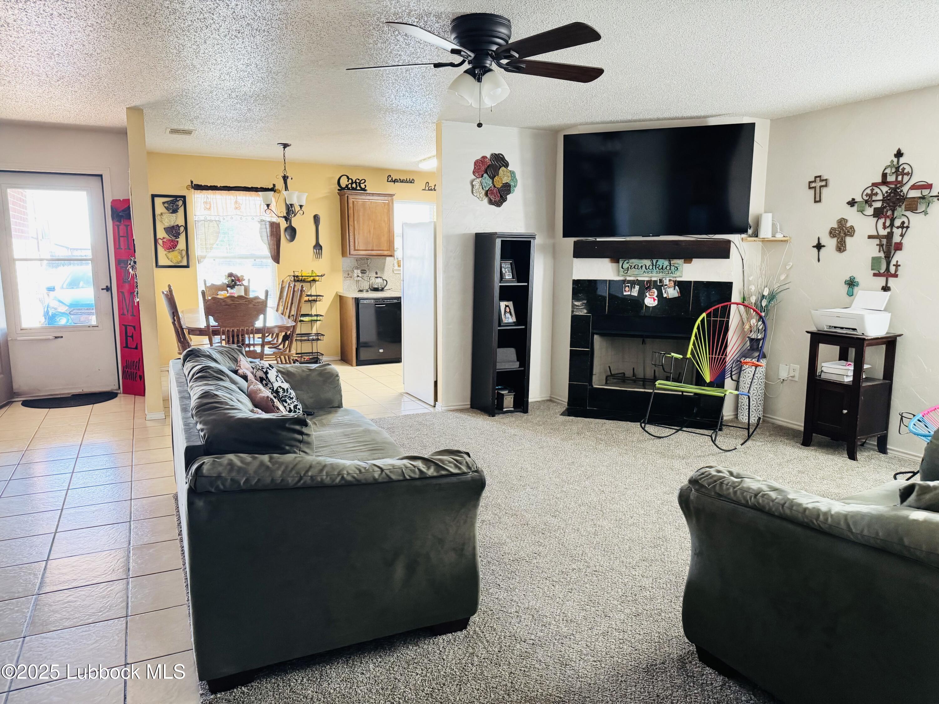 303 77th Street Lubbock, TX 79404 - Photo 2 of 9 a living room with furniture and a flat screen tv
