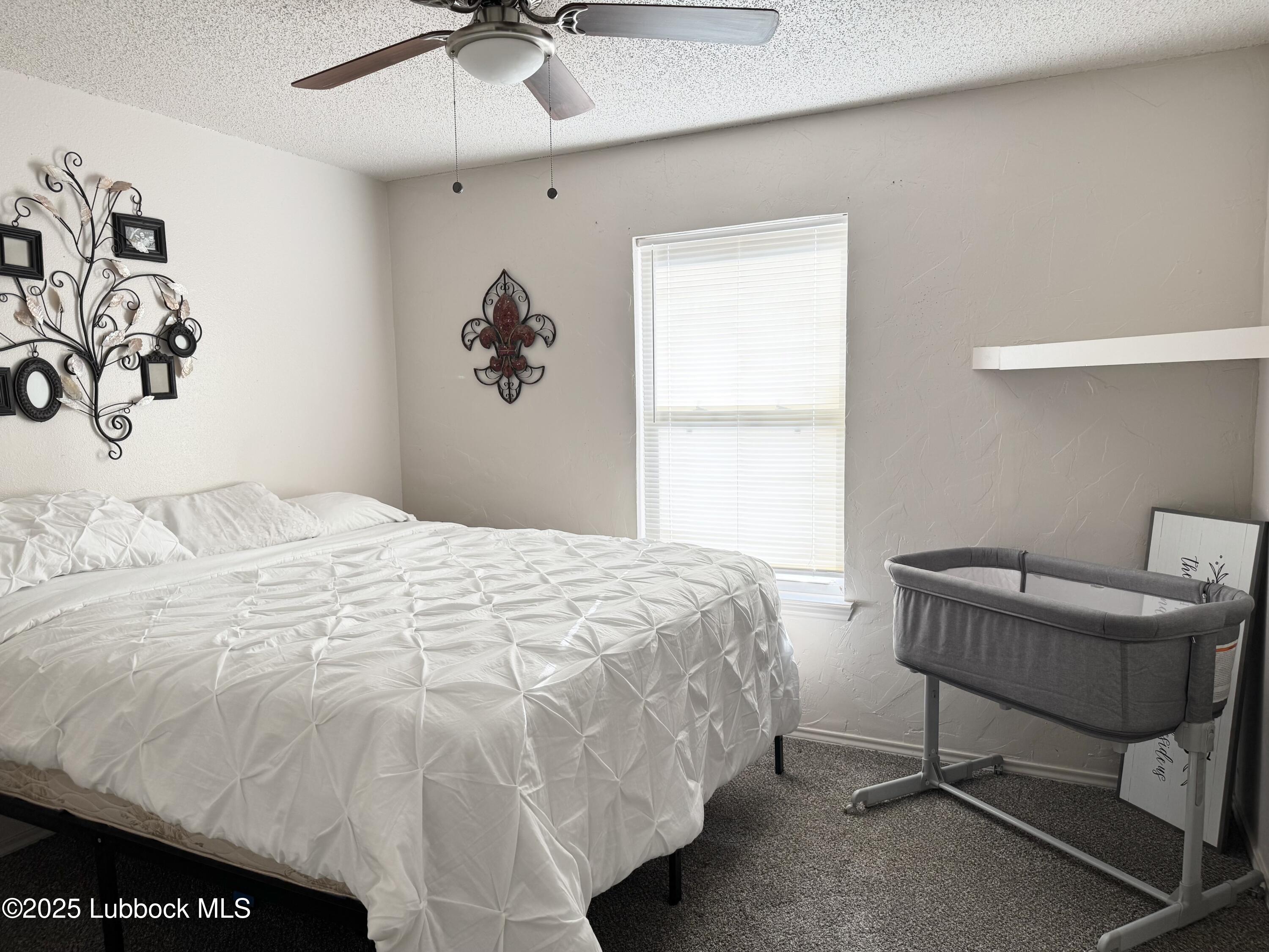 303 77th Street Lubbock, TX 79404 - Photo 6 of 9 a bedroom with a bed and a window