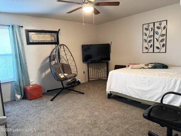 a bedroom with bed and a flat screen tv