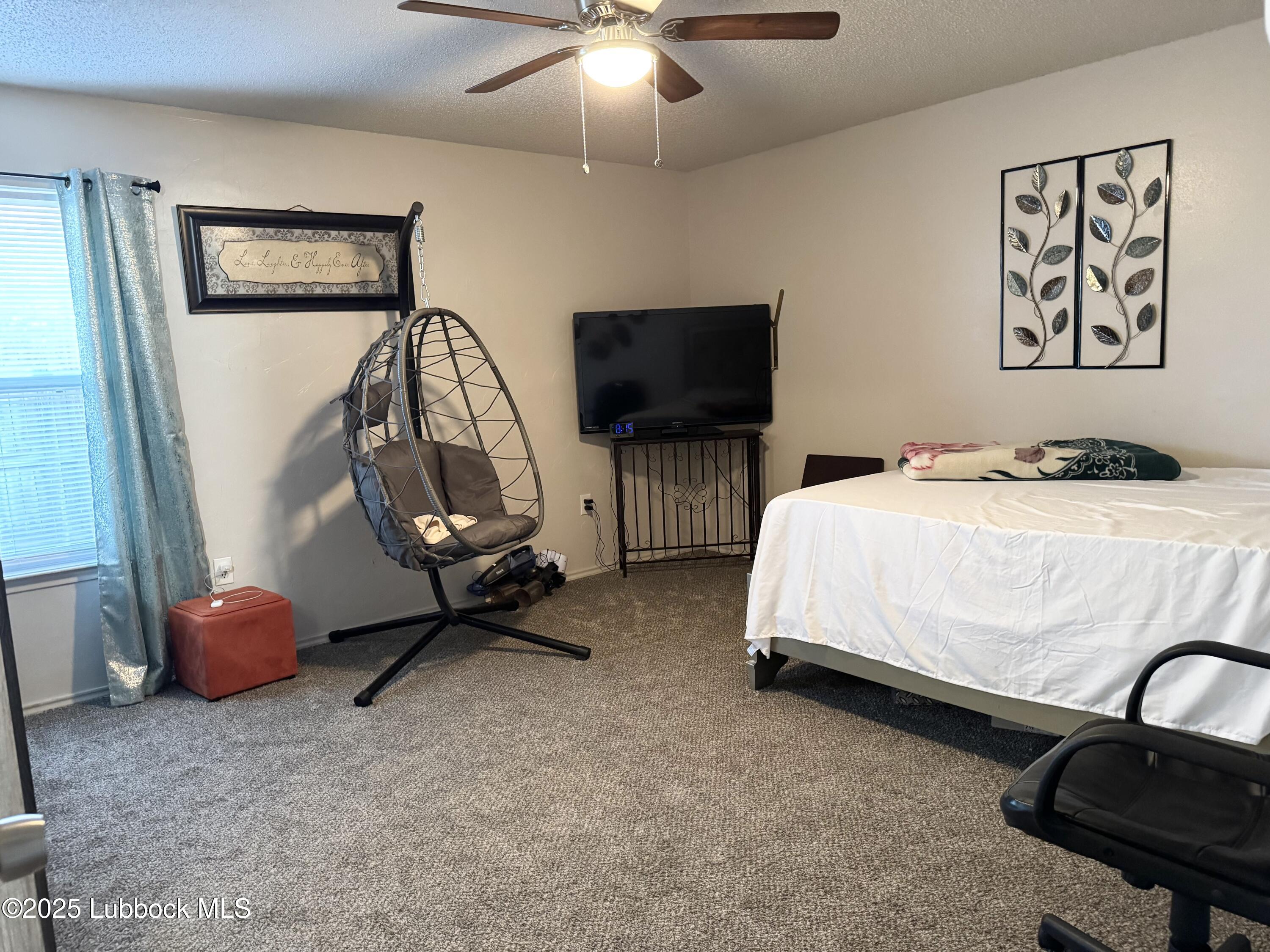 303 77th Street Lubbock, TX 79404 - Photo 9 of 9 a bedroom with bed and a flat screen tv