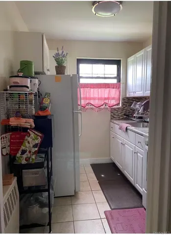 a kitchen with stainless steel appliances kitchen island granite countertop a sink stove and cabinets