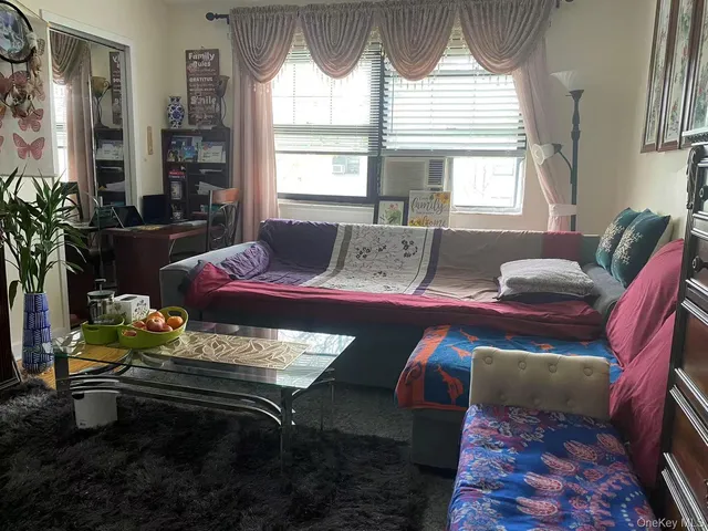 a living room with furniture fireplace and a large window