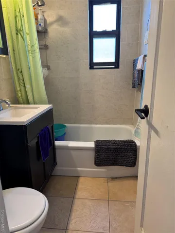 a bathroom with a sink a toilet a vanity and bathtub