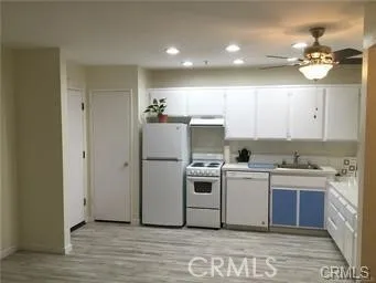 a kitchen with a sink and white cabinets