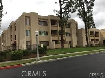 a view of a tall building next to a road