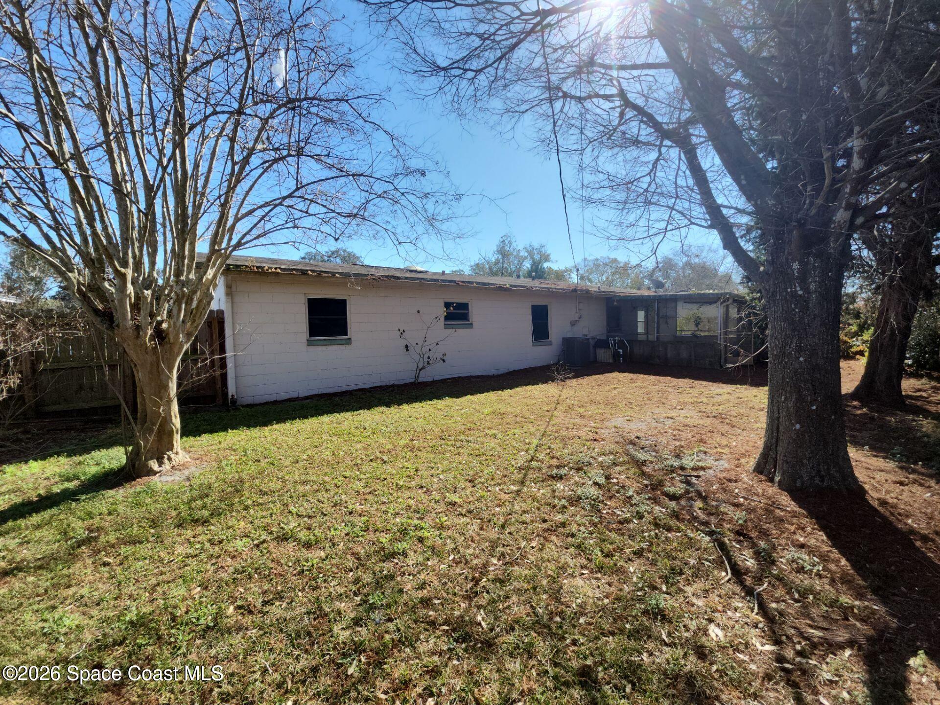 1654 Rice Avenue Titusville, FL 32796 - Photo 18 of 18 a view of a backyard with a large tree