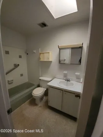 a bathroom with a toilet a sink and bathtub