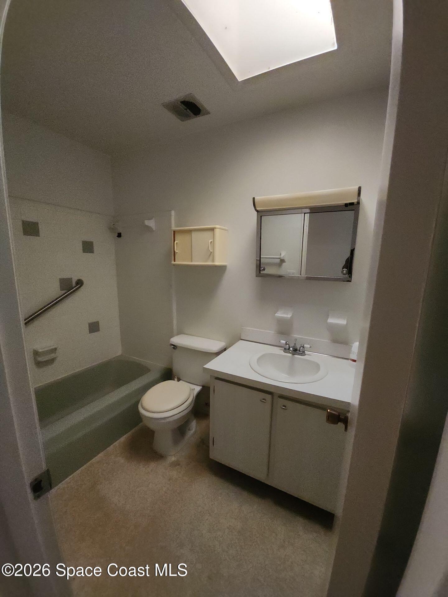 1654 Rice Avenue Titusville, FL 32796 - Photo 9 of 18 a bathroom with a toilet a sink and bathtub
