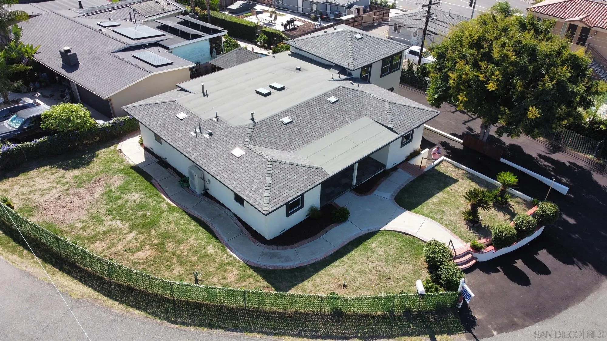 an aerial view of a house with swimming pool and outdoor seating