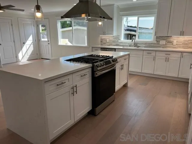 2687 Littleton Road El Cajon, CA 92020 - Photo 2 of 11 a kitchen with stainless steel appliances granite countertop a stove a sink and a microwave
