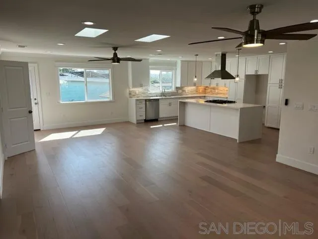 2687 Littleton Road El Cajon, CA 92020 - Photo 4 of 11 a large kitchen with stainless steel appliances kitchen island a large counter top and wooden floors