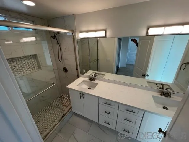 2687 Littleton Road El Cajon, CA 92020 - Photo 5 of 11 a bathroom with a shower sink and mirror