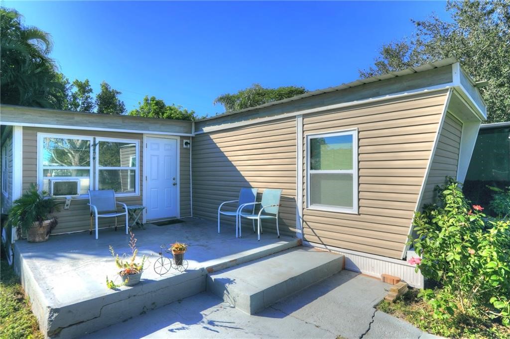 a view of a two chairs in the patio
