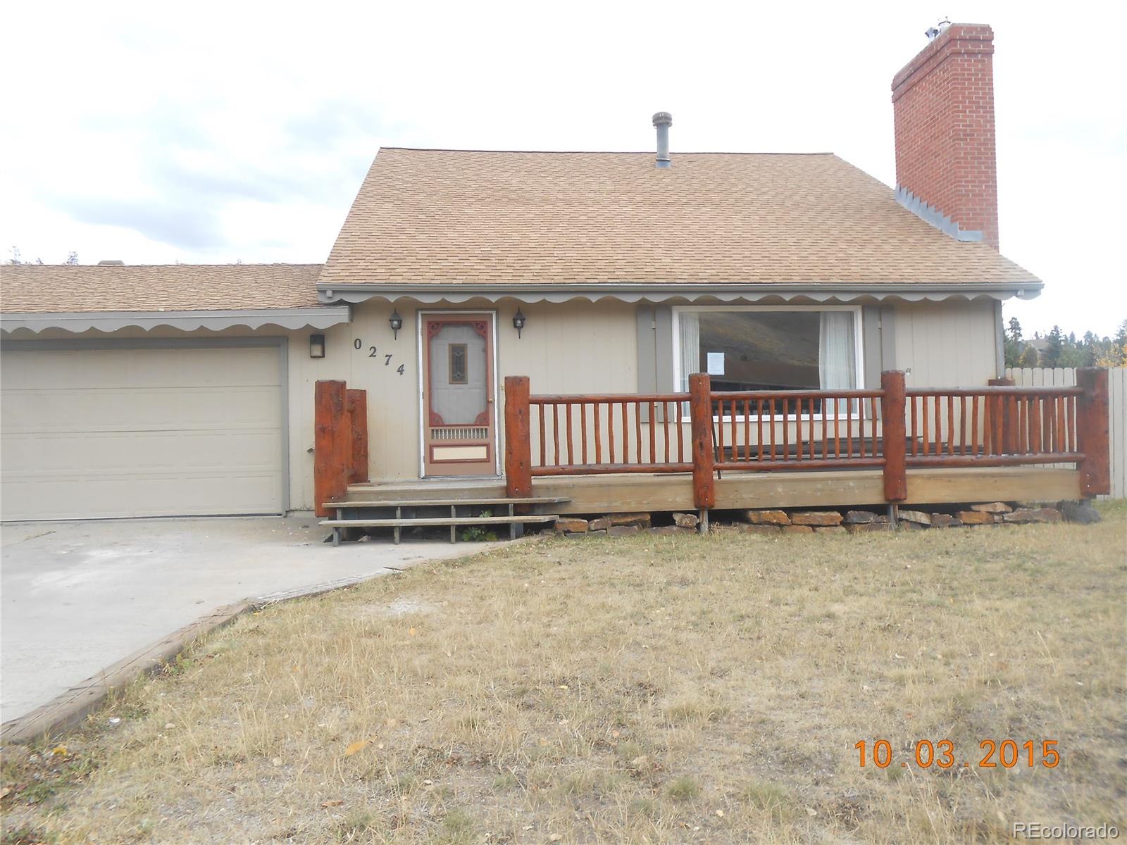 274 Big Elk Road Dillon, CO 80435 - Photo 1 of 15 a white house with a large window and wooden fence