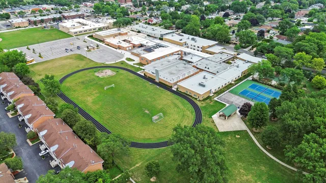 an aerial view of a swimming pool patio and mountain view in back