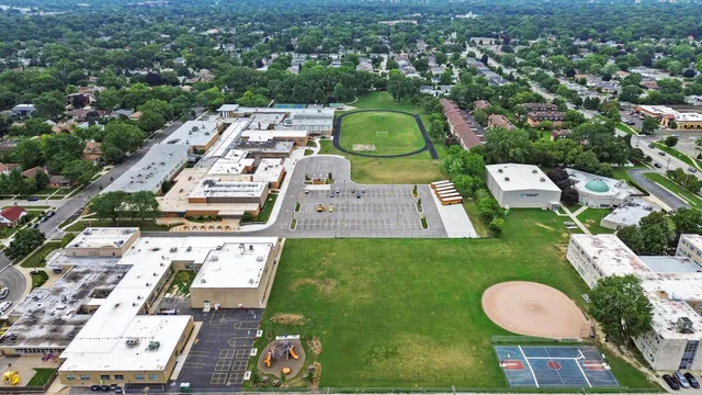 an aerial view of a house with a swimming pool outdoor seating and yard